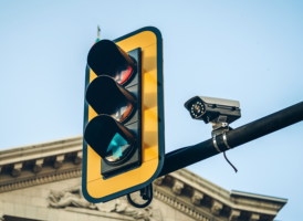 An transportation solution for IoT government applications: A connected traffic light and camera monitoring traffic.