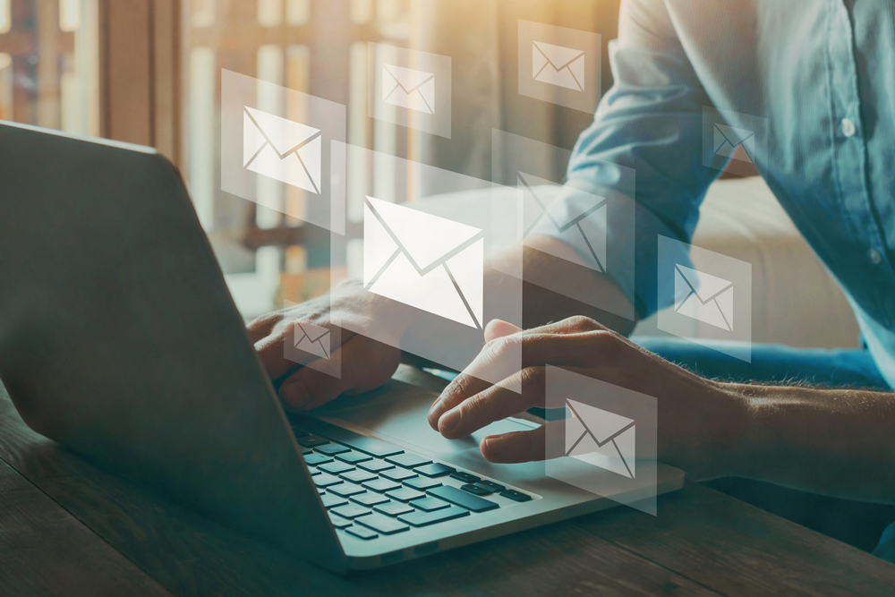 Person sitting at a laptop reading email.