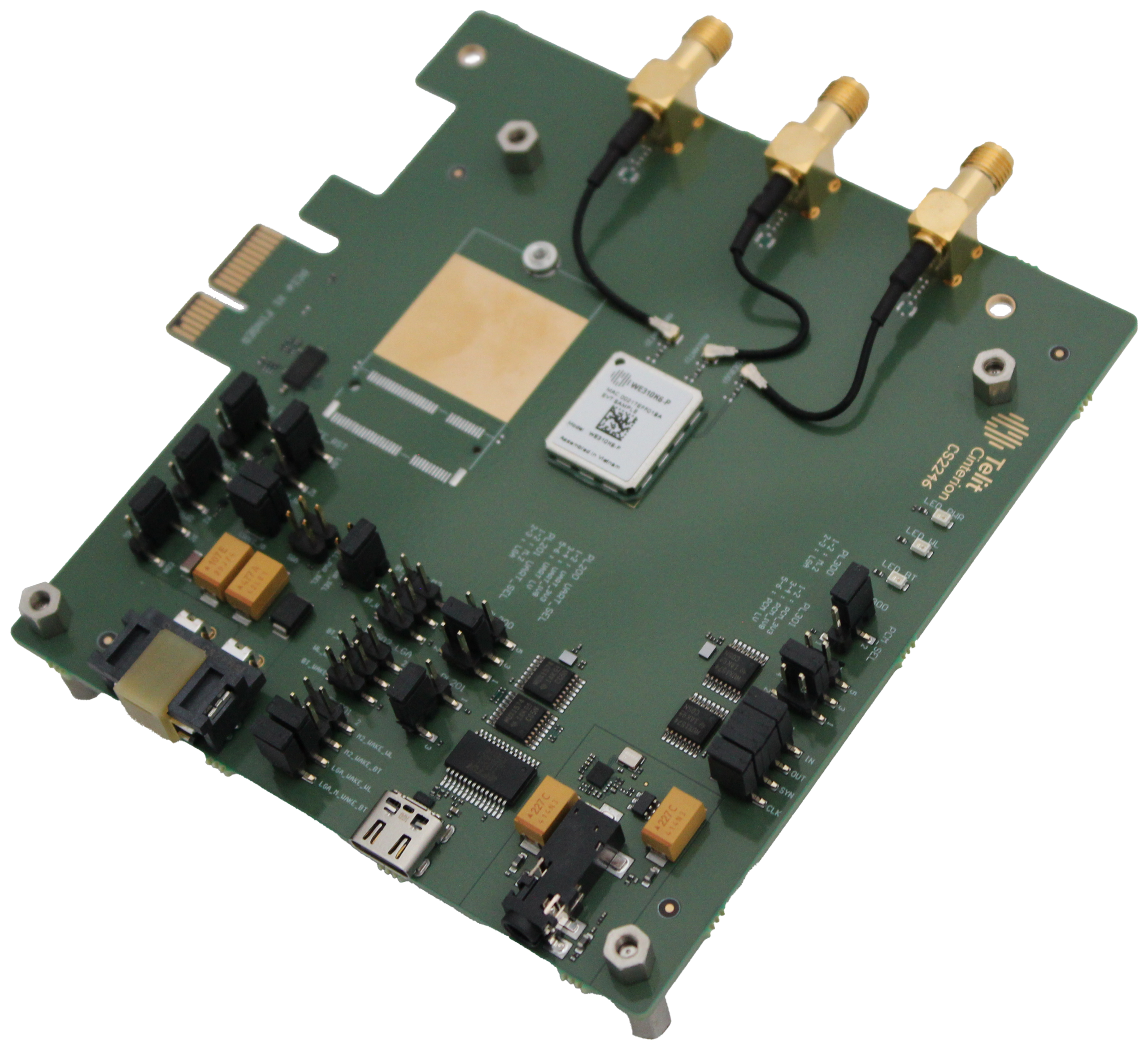 A green board with a number of electronic components on it.