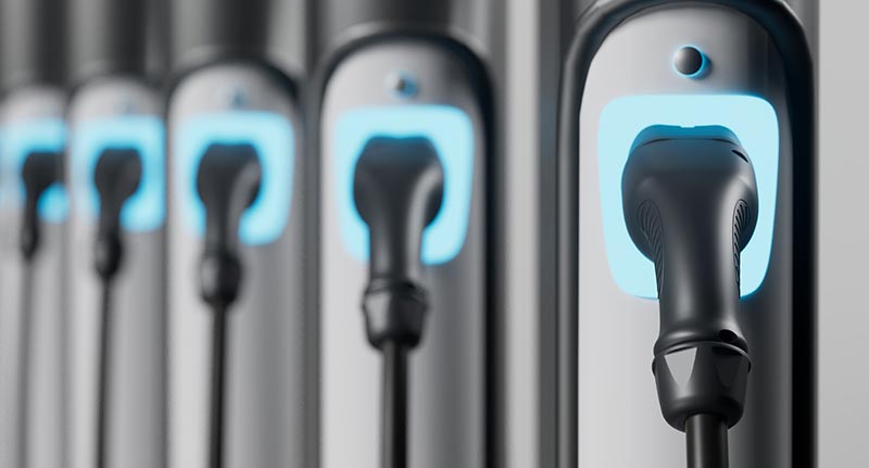 A close-up of a row of EV charging plugs.