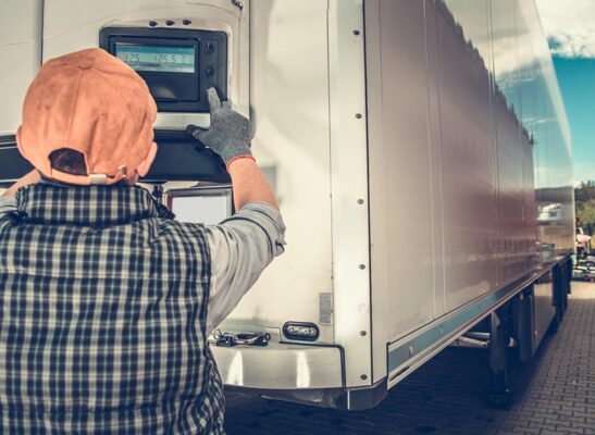 Trucker adjusting temperature in the refrigerated semitrailer.