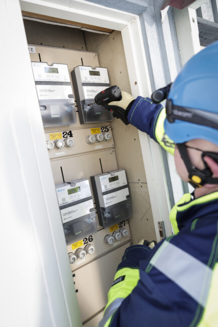 Adion meters with man working one of the meters.