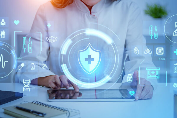 A person in a lab coat uses a tablet, with digital health and security icons projected in front.