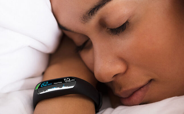 A person dozing with a wearable medical device on their wrist.