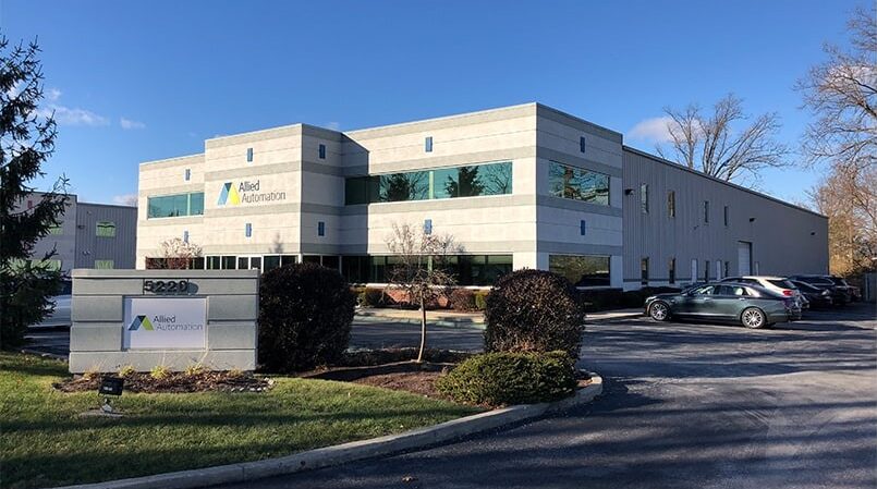 An office building with cars parked in front of it is owned by Allied Automation.