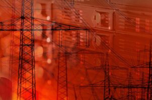 Silhouette of power lines above background of servers.