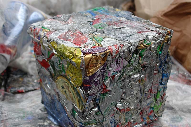 Aluminum cans compressed into a cube.