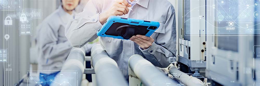 Engineers inspect factory equipment.