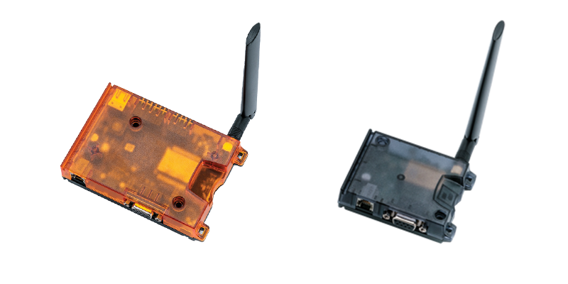 Two cellular IoT gateways, one with an orange transparent casing and the other with a black casing.