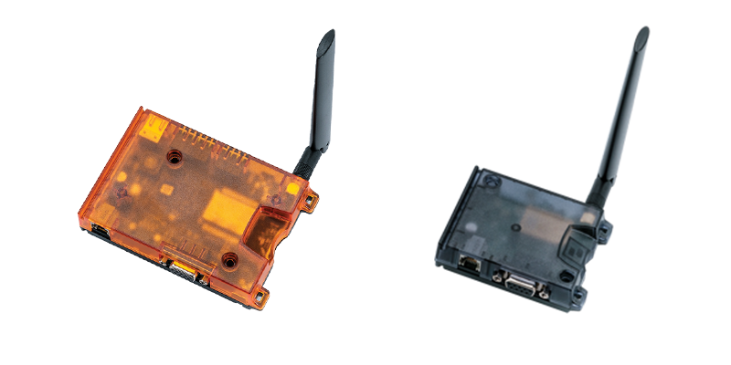 Two cellular IoT gateways, one with an orange transparent casing and the other with a black casing.