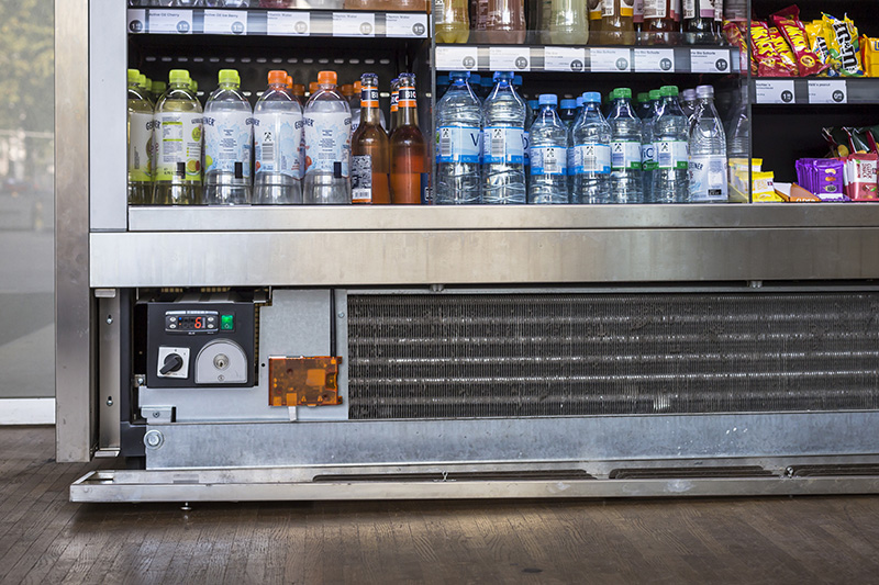An IoT gateway monitoring a commercial beverage and snack refrigerator with a visible temperature control.