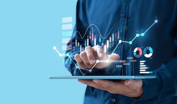 A person interacting with a digital tablet displaying financial graphs and data analysis.