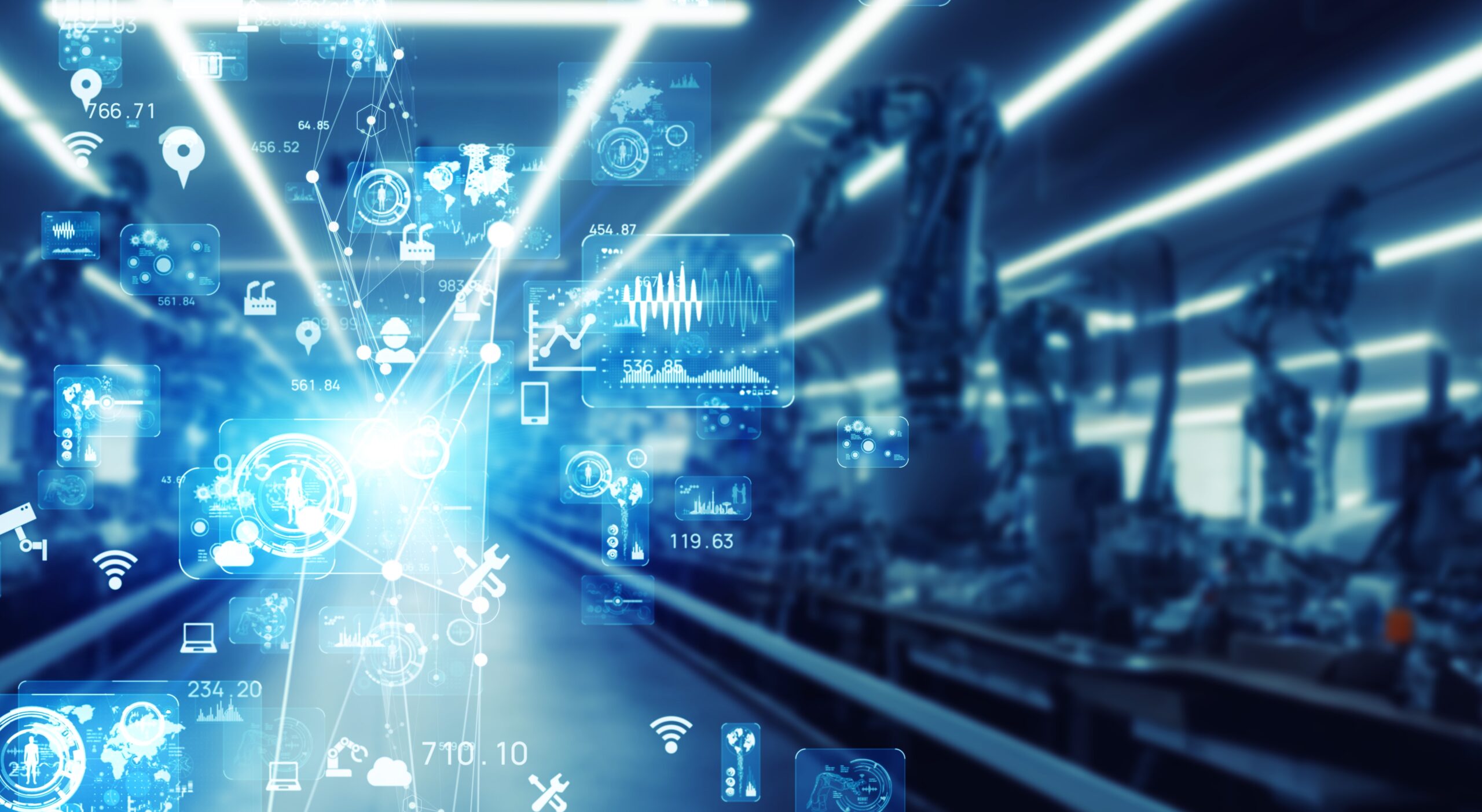 Futuristic manufacturing plant with digital overlays of data and connectivity symbols, illustrating advanced industrial technology in a blurred, dynamic setting.