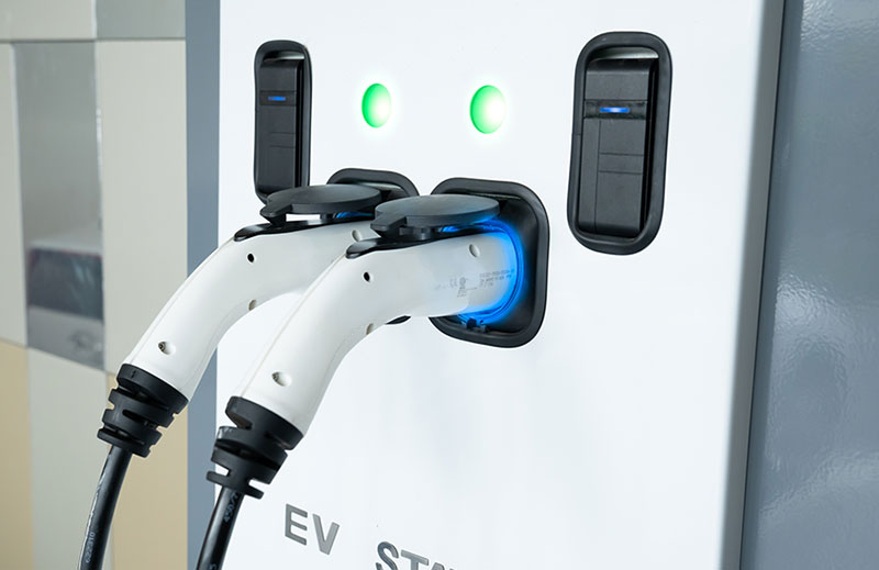 An EV charging station with two charging plugs.