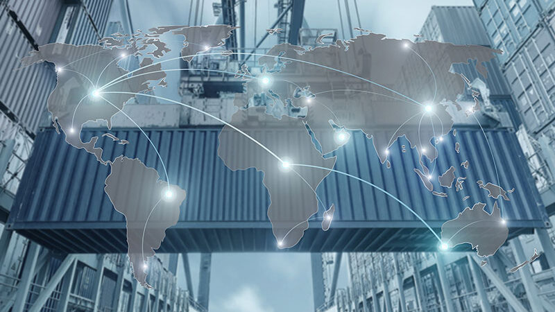 An IoT-enabled supply chain, including a shipping container and a digital world map overlaid with connecting lines.
