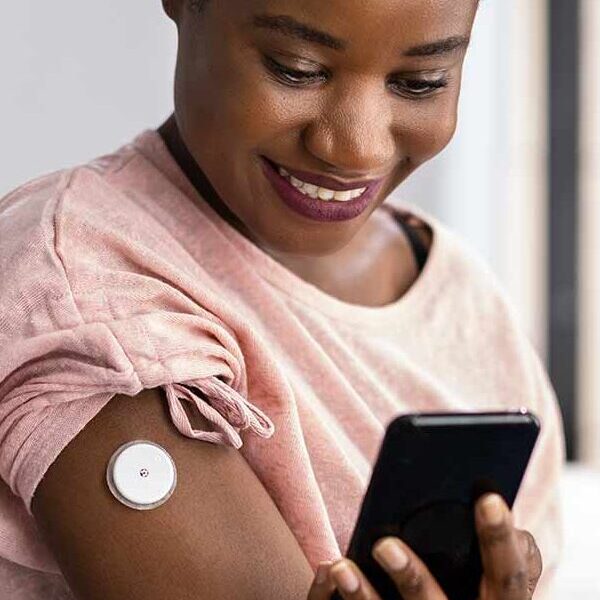 A person checking data from their insulin pump on a smartphone.