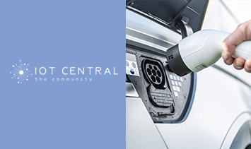 A hand plugs a charging cable into an electric vehicle on the right. On the left, the IoT Central Community logo is displayed on a blue background, emphasizing IoT device development.