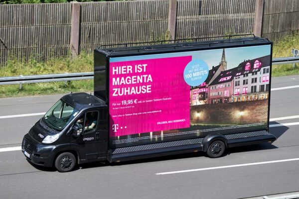 Mobile billboard truck on highway.