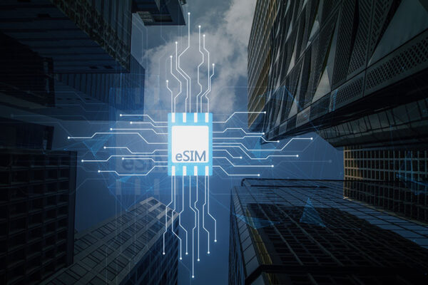 An eSIM graphic is superimposed over a view looking up at tall skyscrapers, symbolizing advanced digital connectivity.