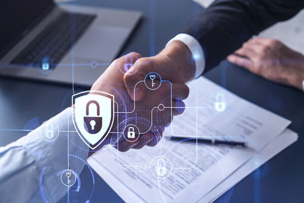 Two people shake hands over a desk with documents and a laptop, overlaid with lock icons symbolizing digital security.