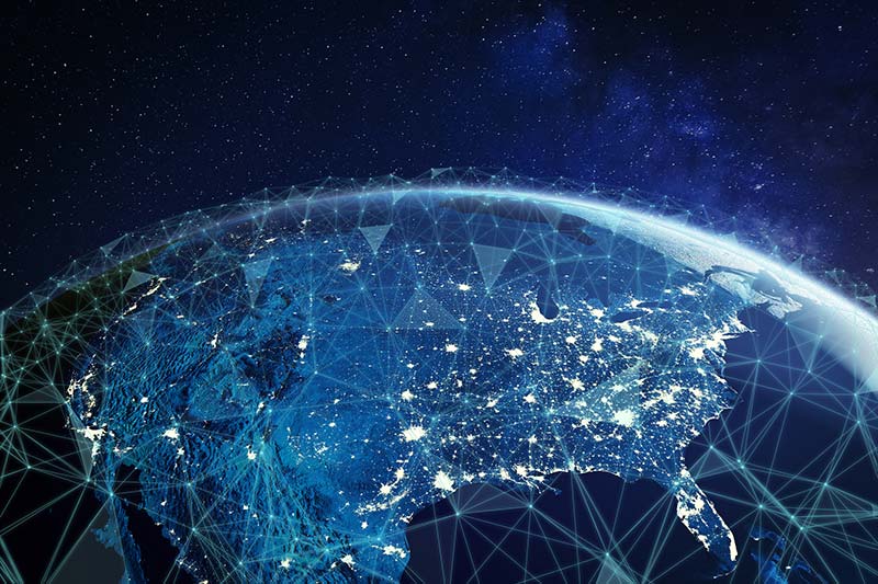 A connectivity network of geometric lines and shapes is overlaid on a globe to represent global, always-on connectivity.