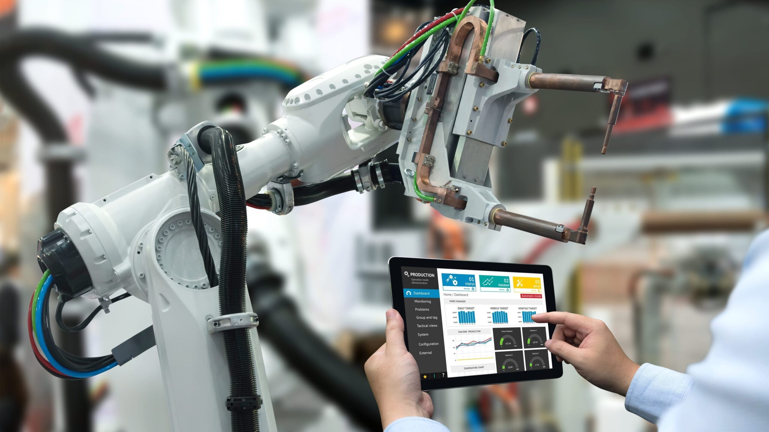A person using a tablet to control a robot.