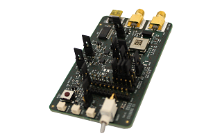A computer circuit board with various components, connectors, and ports, including gold connectors at the top and a white button on the lower left side.