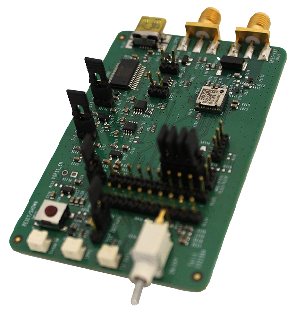 A green circuit board featuring various electronic components, including chips, connectors, and pins, on a white background.