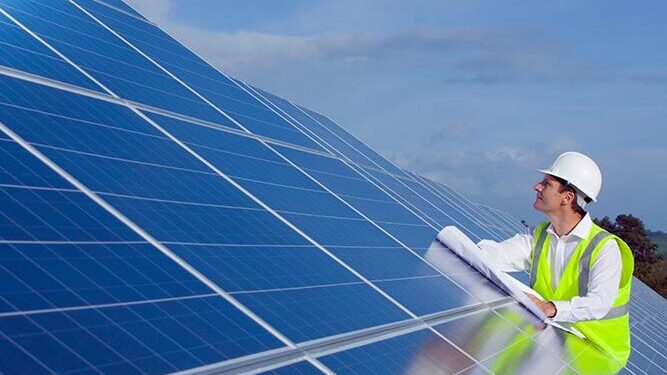 An engineer inspecting solar panels.