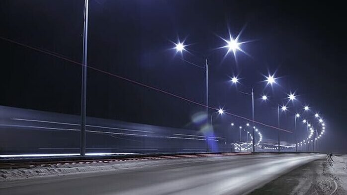 Smart street lighting along a city highway at night.