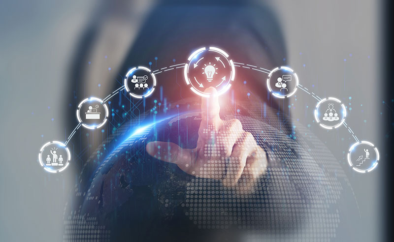 A person stands in the background with their finger touching an icon with circular arrows and a lightbulb to represent business continuity.