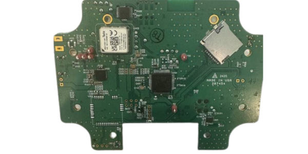 Green circuit board with various electronic components, including microchips, a QR code, and a slot for a memory card. Text: "MADE IN USA.
