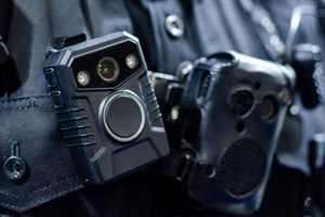 A close-up of a body camera attached to a police uniform.