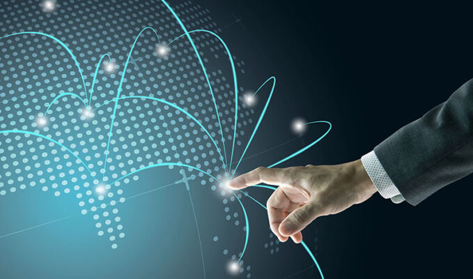 A hand in a suit touches a glowing point on a digital globe with connecting lines and dots, representing corporate SD-WANs.