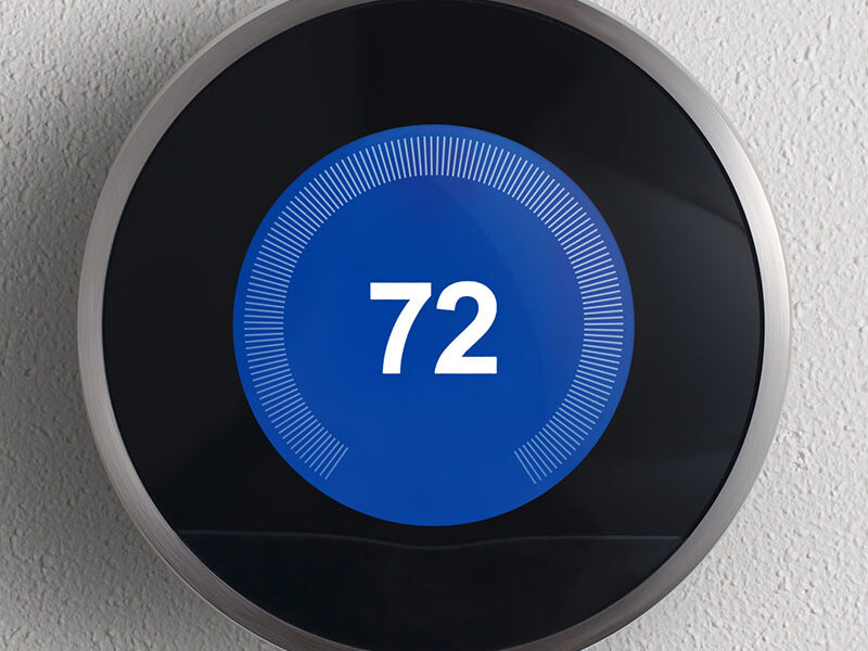 A digital indoor thermometer with a blue background, displaying a temperature of 72.