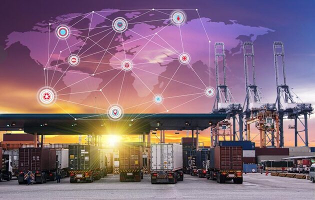 Trucks line up at a shipping port with cargo containers. In the sunset sky is a glowing world map with connected network nodes.