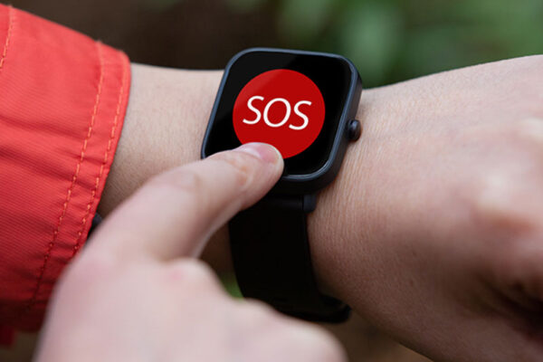 A person presses a large red SOS button on a smartwatch.