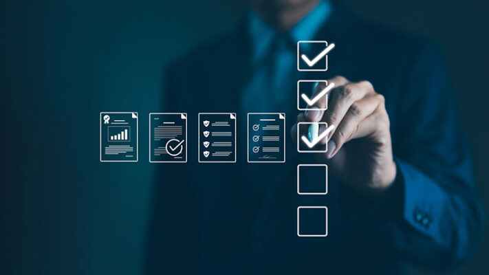 A person in a suit checks off boxes on a virtual checklist, with icons representing documents and completed tasks in the foreground.