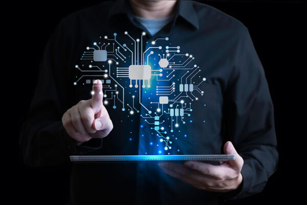 A person interacts with a digital tablet displaying a glowing circuit board brain.