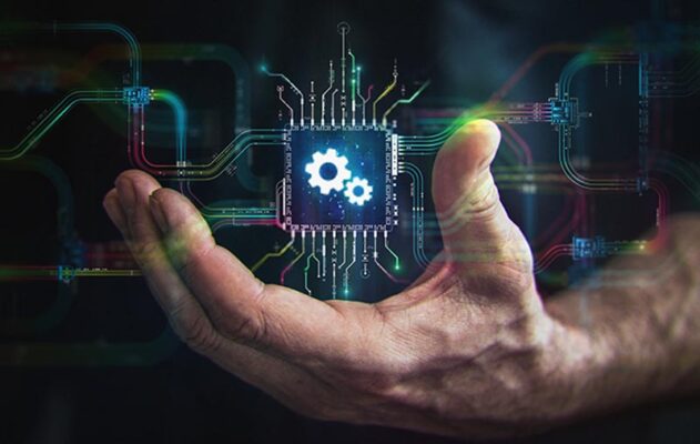 A hand holds a digital representation of a smart module with two gears on the front.