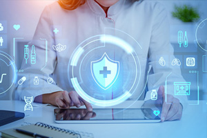 A person in a lab coat uses a tablet with digital healthcare and medical icons overlayed.