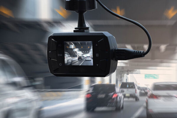 A dashboard camera records footage of busy traffic on a multilane road.