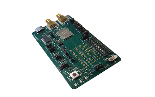 A green printed circuit board with various electronic components, connectors, and gold-plated ports on one end, placed on a white background.