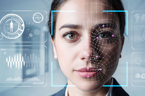 A woman’s face is overlaid with digital facial recognition graphics and data visualizations, illustrating biometric technology.