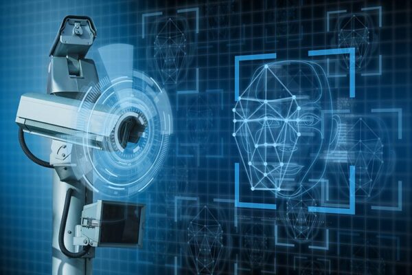 A security camera scans a digital facial recognition interface, signifying edge computing.