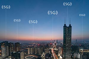 Cityscape at dusk with 5G network icons indicating wireless connectivity points across multiple buildings.