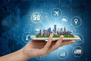 A hand holds a smartphone displaying a cityscape, with digital icons and "5G" text.