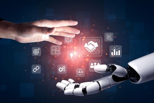 Digital business icons float between a human hand and a robotic hand, symbolizing collaboration between humans and artificial intelligence.