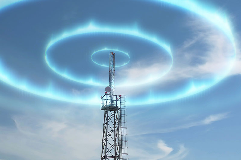 Telecommunication tower with blue concentric rings of light radiating outward in the sky, suggesting signal transmission or wireless communication.
