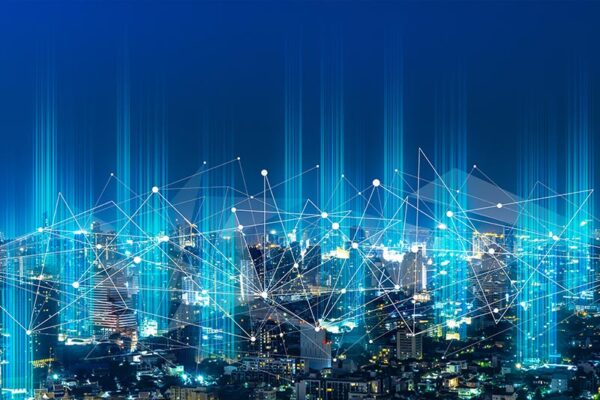 Nighttime city skyline with digital lines and nodes overlay, representing a connected network.